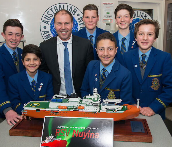 Students posing with Minister and model ship