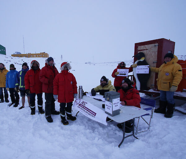 Expeditioners at Davis research station standing in line to vote at an election polling station on the sea ice.