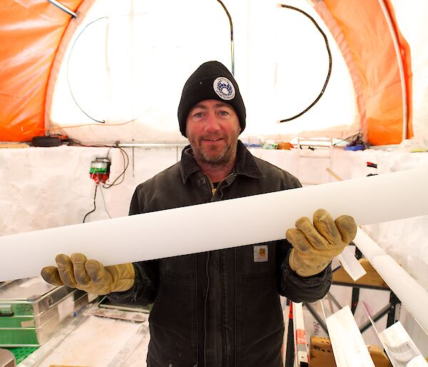 Dr Mark Curran holds up a one-metre length of ice core.