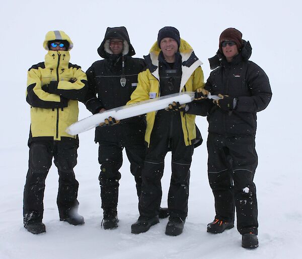Scientists holding ice core