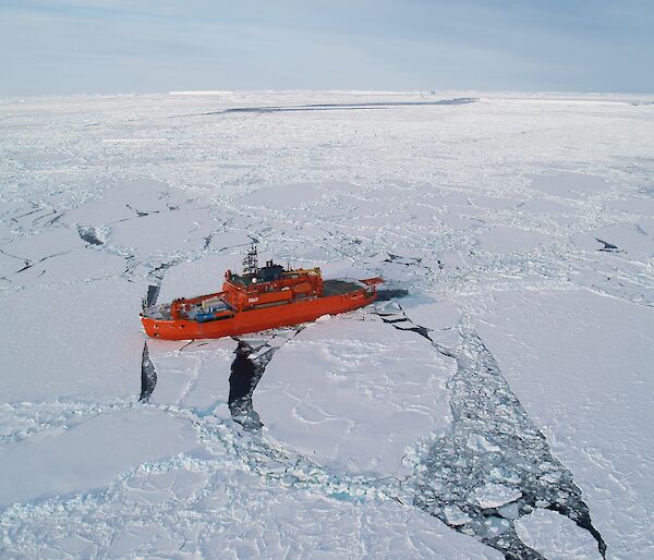 Aerial shot of the the ship surrounded by ice.