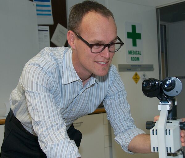 Dr Graham Denyer with microscope