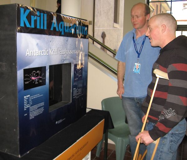 Marine scientist Rob King (left) discusses Antarctic krill with a visitor.