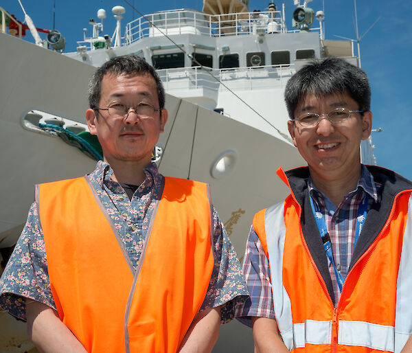 Two scientists, Tokyo University’s Dr Masato Moteki and Australian Antarctic Division’s Dr So Kawaguchi, on the dock next to the Japanese ship the Umitaka Maru