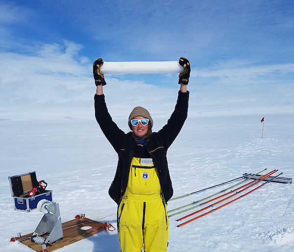 PhD student Madi Gamble Rosevear holding an ice core on the Totten Glacier, near Australia’s Casey research station