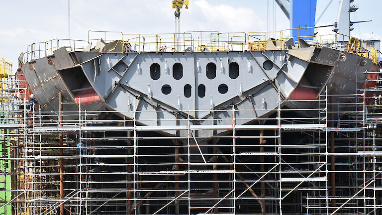 The bow of the ship with ‘anchor pockets’ (recesses to house the anchors) visible on each side of the ship.