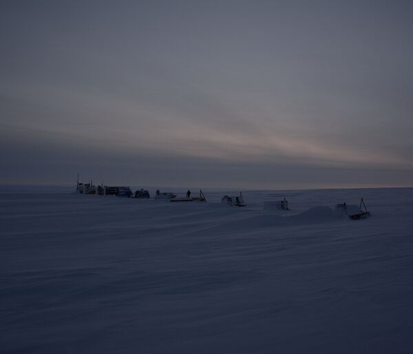 Remote camp with a series of modules spaced evenly in a line on ice