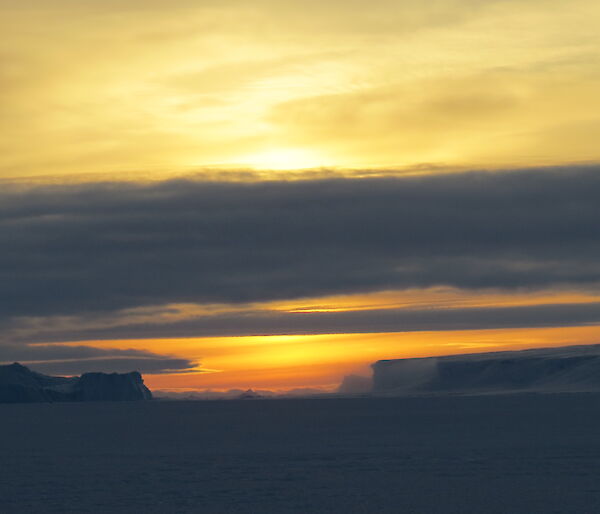 A sunrise sky with icebergs