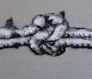 An artwork, paint and stitching on stretched linen, depicts a knot in a rope.