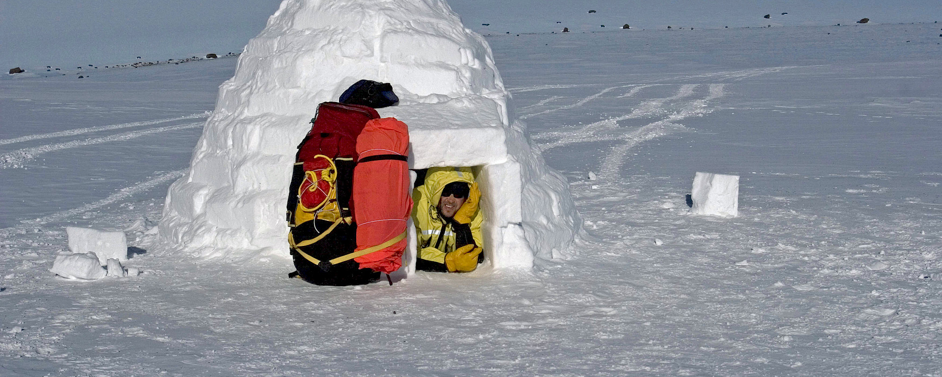 Expeditioner in entry of completed igloo