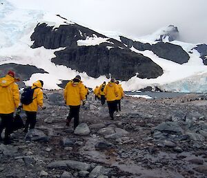 Tourists walking carefully across ice-free land