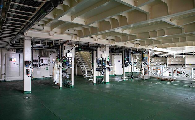 Poles that provide connection points for services to containers, on the ship's deck.