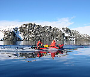 Small boat with iceberg in background.
