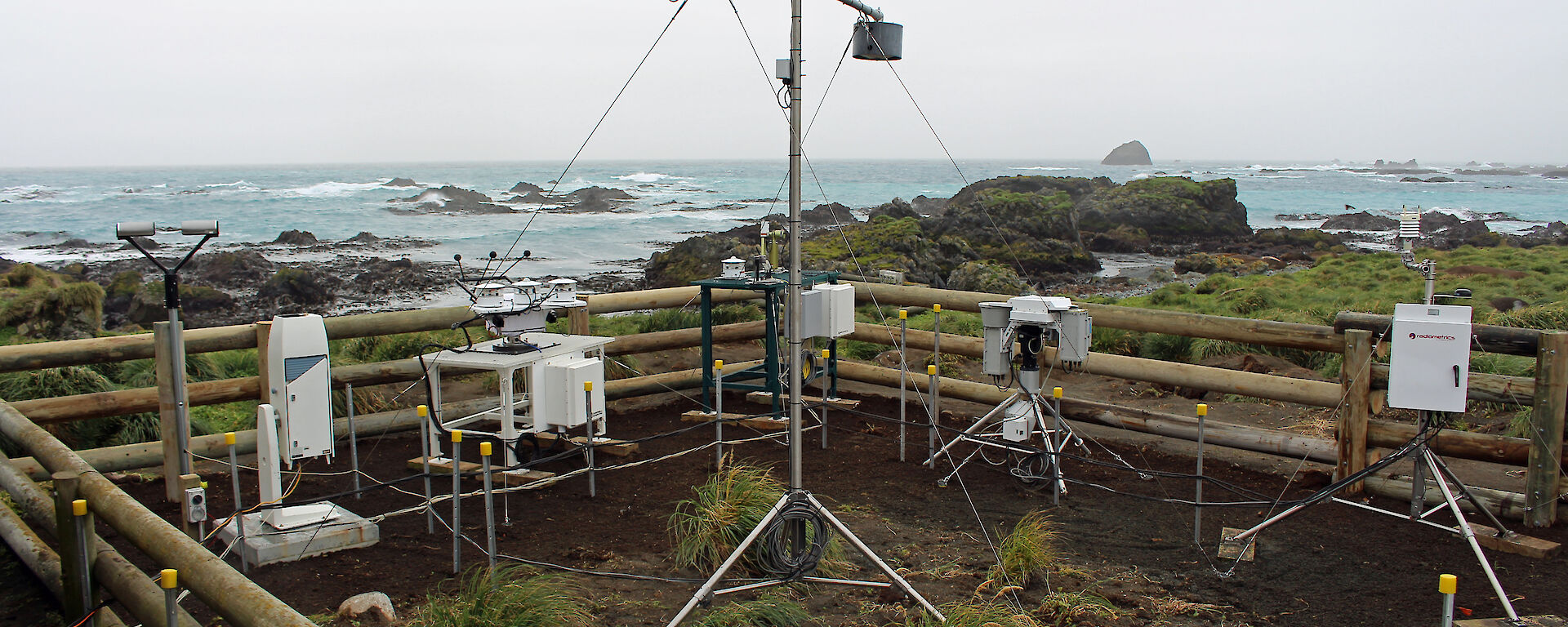 A range of atmospheric instruments inside a fenced area on Macquarie Island.