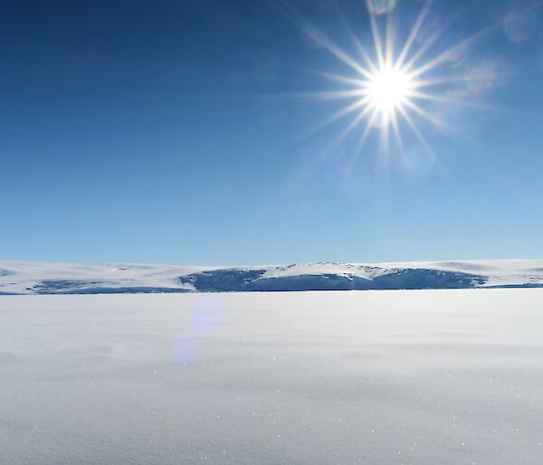 Landscape of the sun over the sea ice and ice cliffs