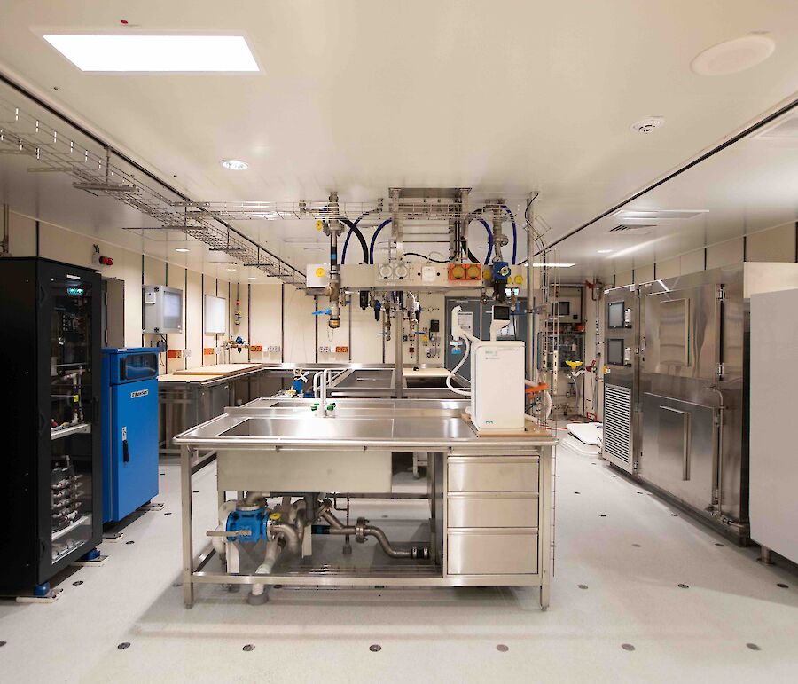 A marine laboratory with sinks,benches, storage cupboards and scientific equipment.