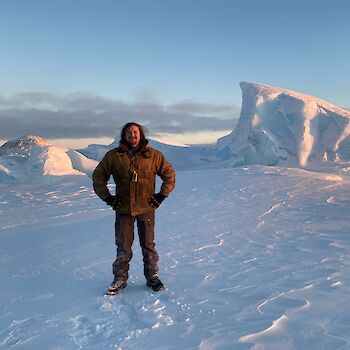 Expeditioner Steve 'Muscles' Middleton standing in an Antarctic landscape
