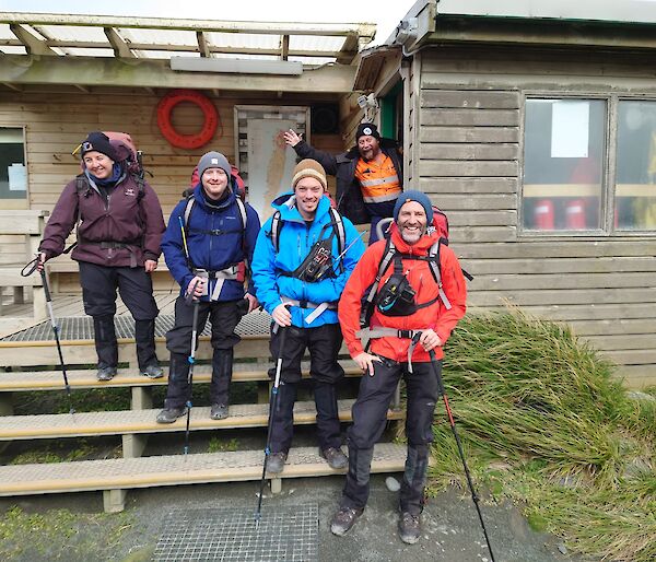 Group of Expeditioners in front of the main mess ready to depart station