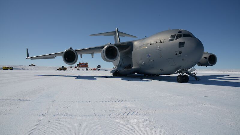 A grey defence force plane sits on the ice.