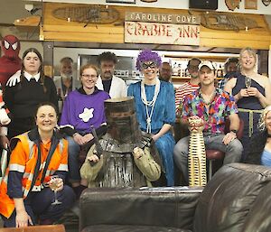 People dressed up like pirates and other characters smiling at the camera