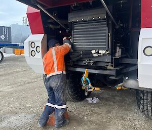 Alex with his back to the camera, the Terrabus underbonnet in the background