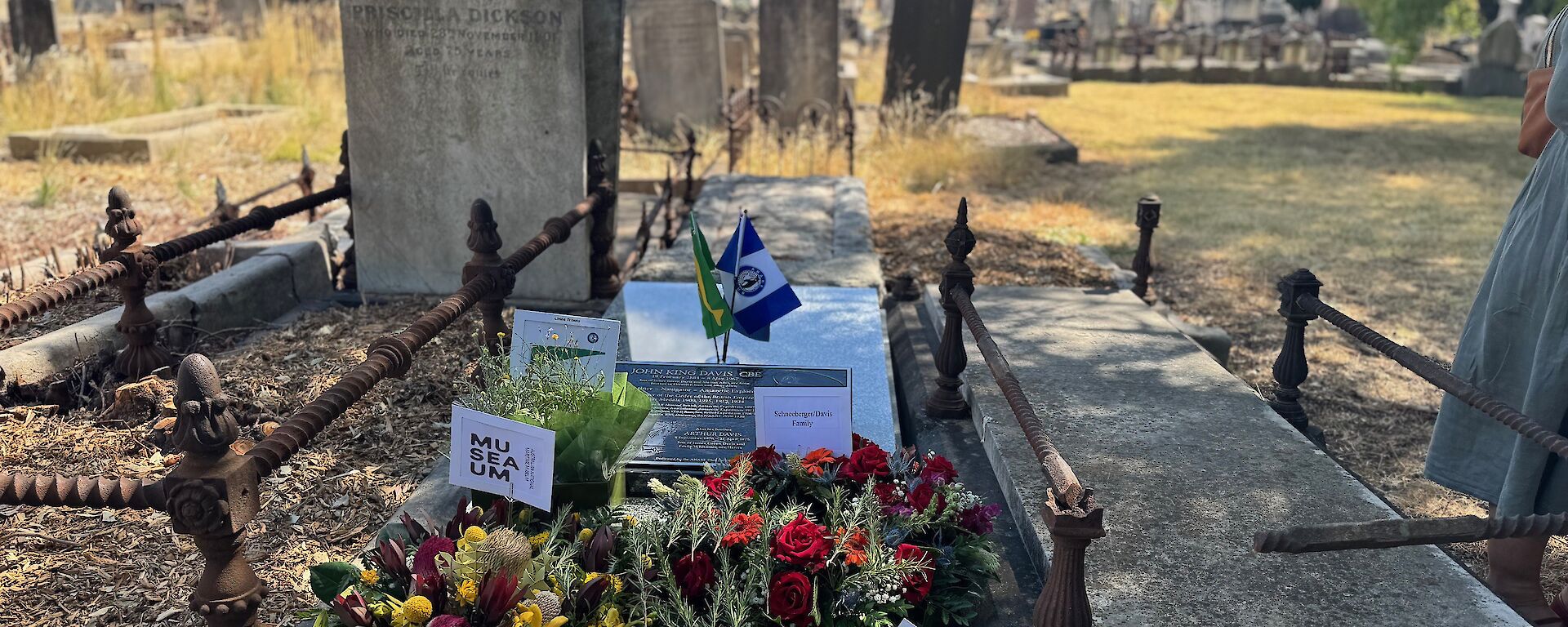 Flowers and cards placed on a grave in a cemetery