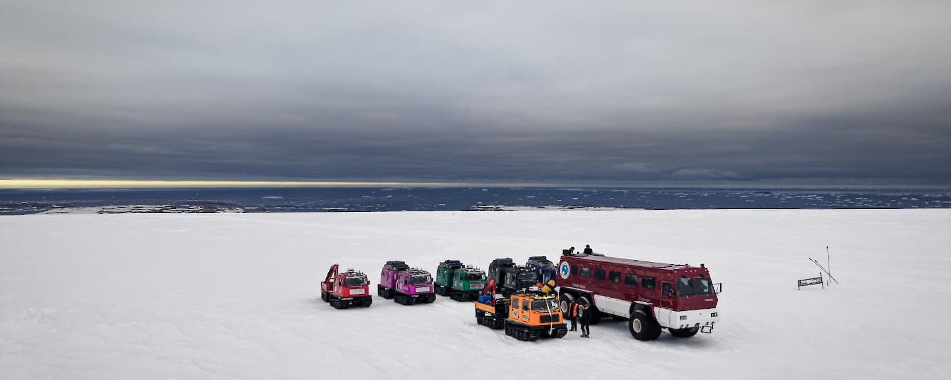 Wide shote of Terrebus and all terrain vehicles on ice