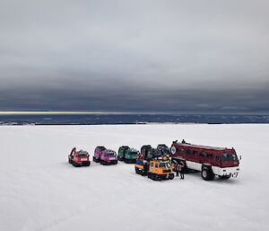 Wide shote of Terrebus and all terrain vehicles on ice