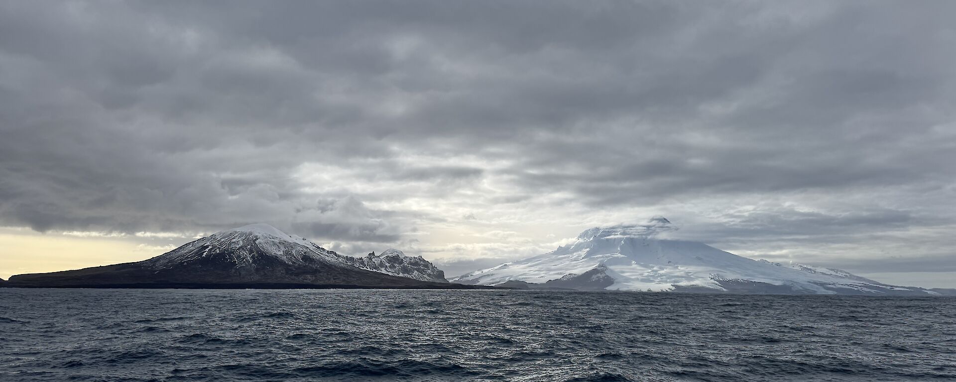 Mountain peaks on an island with sea in the foreground