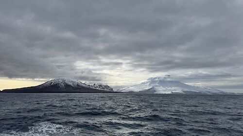 Mountain peaks on an island with sea in the foreground