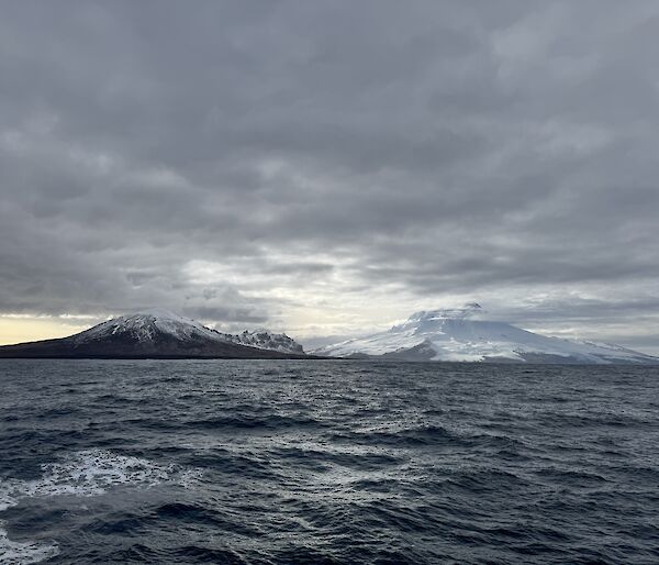 Mountain peaks on an island with sea in the foreground