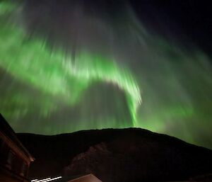 A curtain of green, white and purple light in the night sky