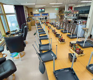 photo showing mess tables and chairs, next to the kitchen