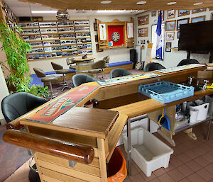 Mawson's bar, overlooking previous ANARE/AAP wintering expeditioner photos on the walls and the station's dart board