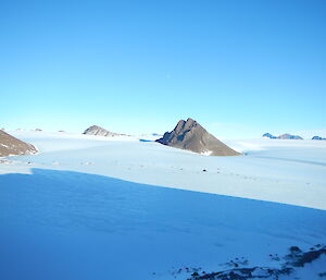 picture of dispersed rocky outcrops on the plateau behind Mawson Station
