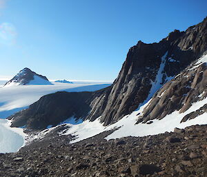 Looking down from a mountain, with a view of blue ice and mountain features