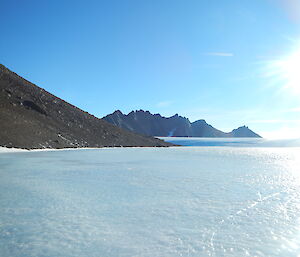 picture of blue ice, with rocky mountain features in background