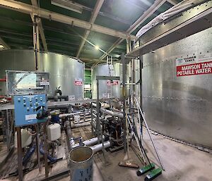 Inside Mawson's tank house, showing 3 x 70,000 litre water tanks, pumps, pipes and control panels.