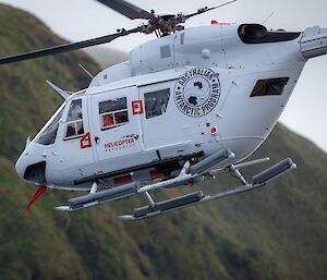 Close-up view of a helicopter flying overhead.