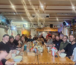 A group of people sitting around a large table