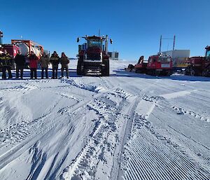 three large tractors sitting on the snow and ice in Antarctica