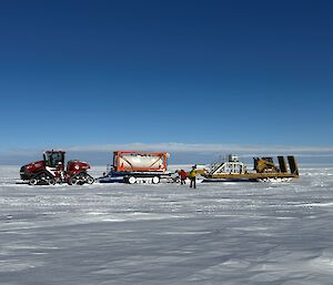 a tractor towing equipment across the ice