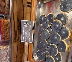 A plate full of round black cookies
