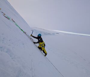 A person climbing an ice cliff