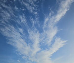 Streaky clouds above a rocky landscape