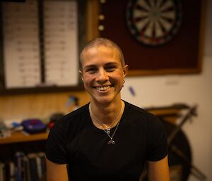A woman with a closely shaved head.