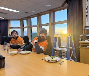A ladder propped up against the mess dining table, with a meal in front of it while 'talking' with an expeditioner