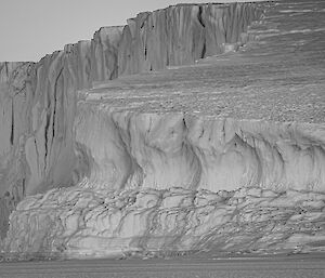 A black and white photo of another corner of the iceberg - showing the patterns and indentations of iceberg walls