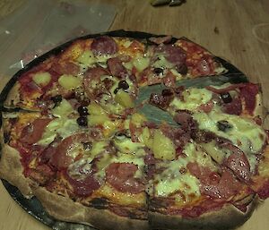 A pizza cut into triangles, on a round dish.