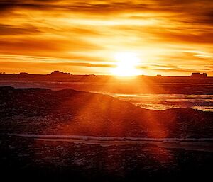 An orange sunset over ice.